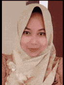 a close up of a woman wearing a hijab and smiling .