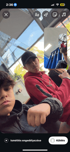 a screenshot of a phone screen shows a man in a red hoodie and a boy in a black jacket
