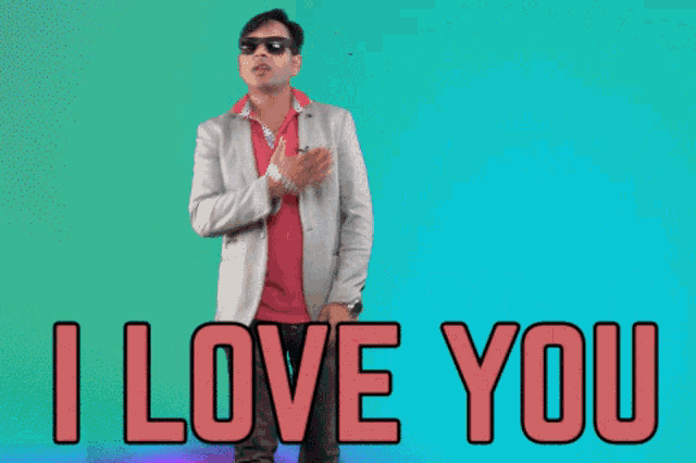 a man wearing sunglasses and a suit stands in front of a sign that says " i love you "