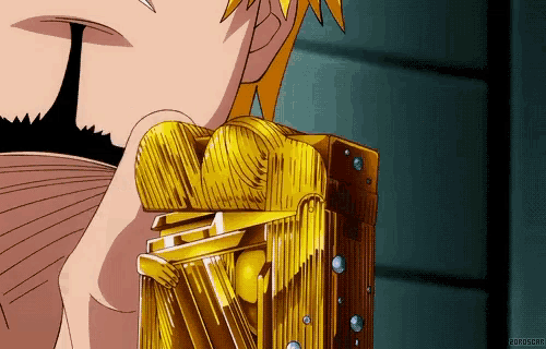 a close up of a person holding a gold object