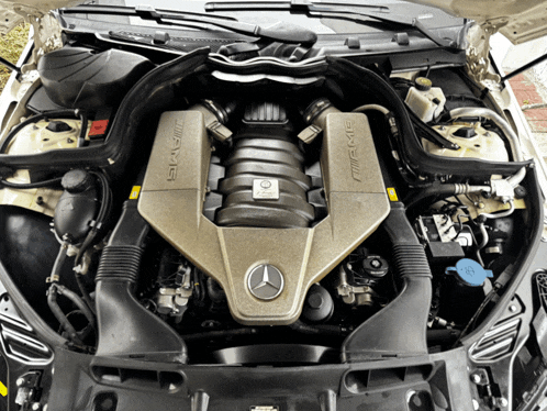 the engine of a mercedes with the hood open