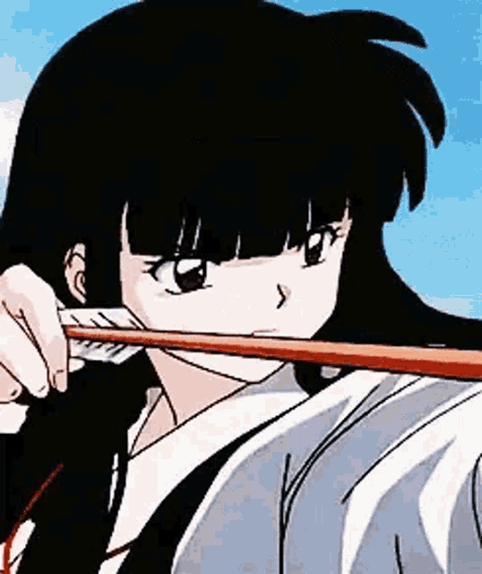 a girl with long black hair is holding a bow and arrow in her hand .