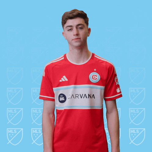 a man is wearing a red shirt with the word carvana on it