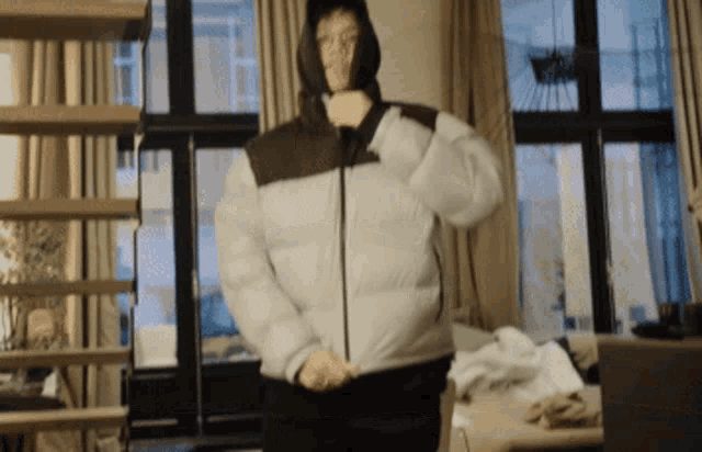 a person wearing a puffer jacket with a hood