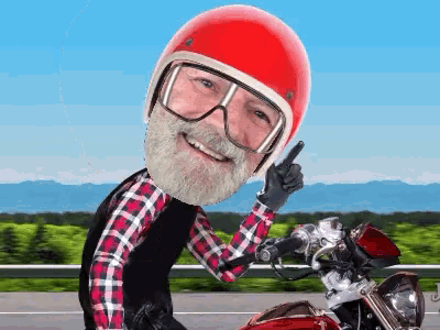 a man wearing a red helmet and goggles is pointing
