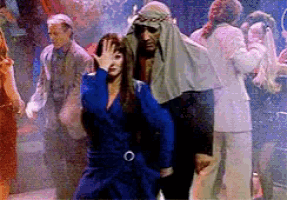 a woman in a blue dress is covering her face with her hand in front of a crowd