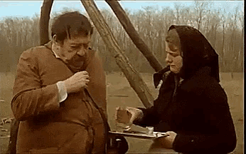 a man and woman are standing next to each other in a field .