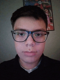 a young man wearing glasses is taking a selfie