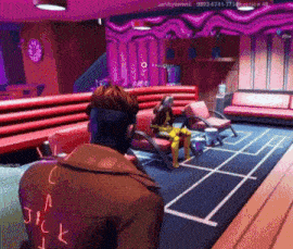 a man in a jacket with jack written on the back is playing a video game