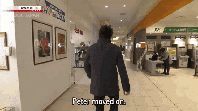 a man walking down a hallway with the words peter moved on on the bottom