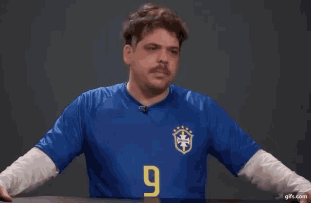 a man wearing a blue shirt with the word mas on it