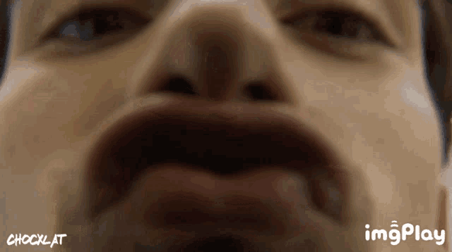 a close up of a man 's face with the words imgplay behind him
