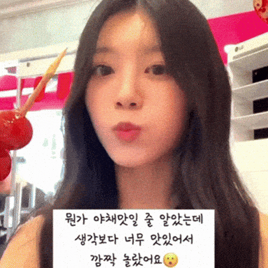 a woman is holding a sign that says ' i love you ' in korean