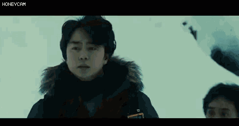 a person is laying in the snow with chinese writing on the bottom