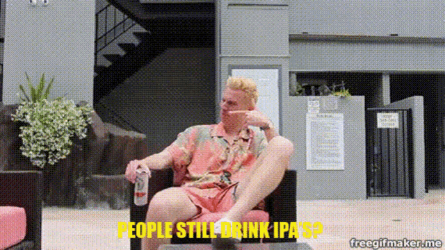 a man is sitting in a chair with a bottle of beer in his hand and the words " people still drink ipa 's " above him