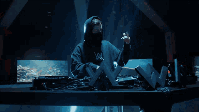 a man in a black hoodie with the letter n on the front