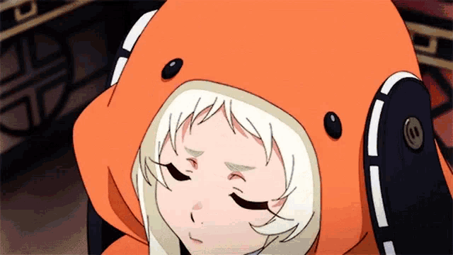 a close up of a girl wearing an orange hoodie with headphones on her head .