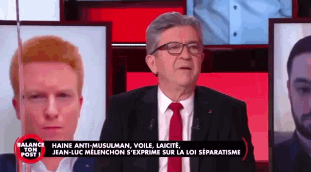 a man in a suit and tie is on a television show