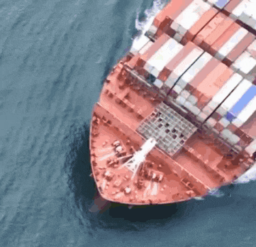 an aerial view of a large cargo ship in the ocean