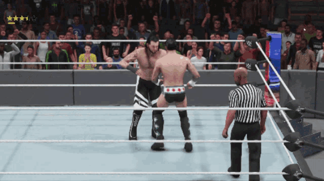 two wrestlers are fighting in a ring with a referee in the background