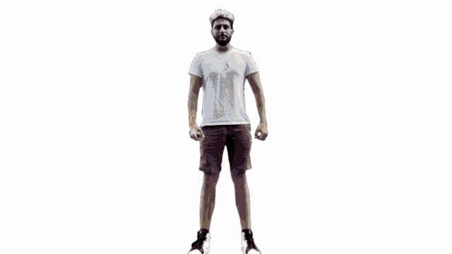 a man with a beard is standing in front of a white wall