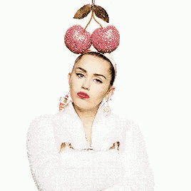 a woman wearing a headband with two cherries on top of her head