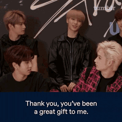 a group of young men are sitting in front of a wall with the words thank you you 've been a great gift to me