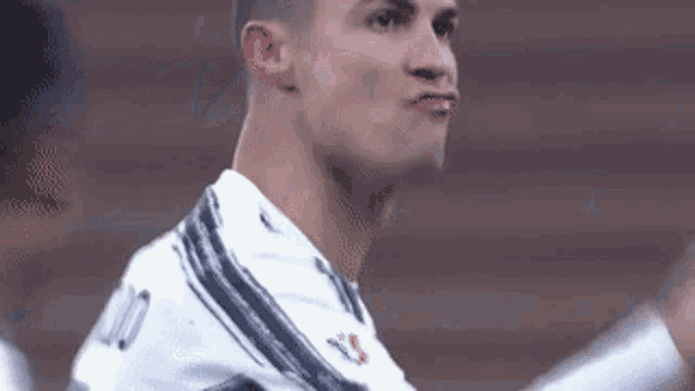 a close up of a soccer player making a funny face with his mouth open .