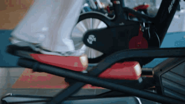 a person is riding an elliptical with the letter s on the pedal