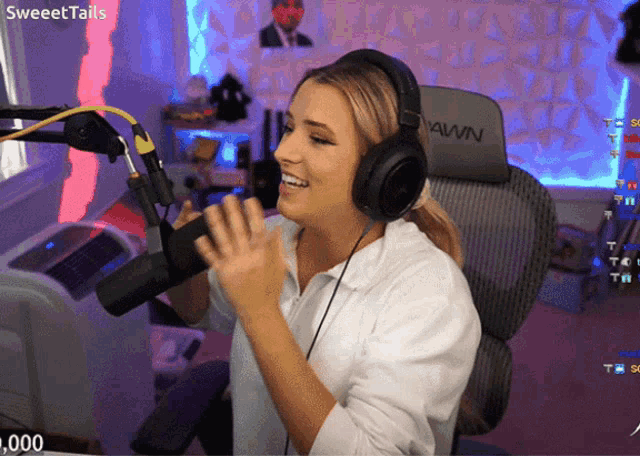 a woman wearing headphones is sitting in front of a microphone with the words sweettails on the top left