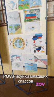 a display of children 's drawings on a stand with zov written in the corner