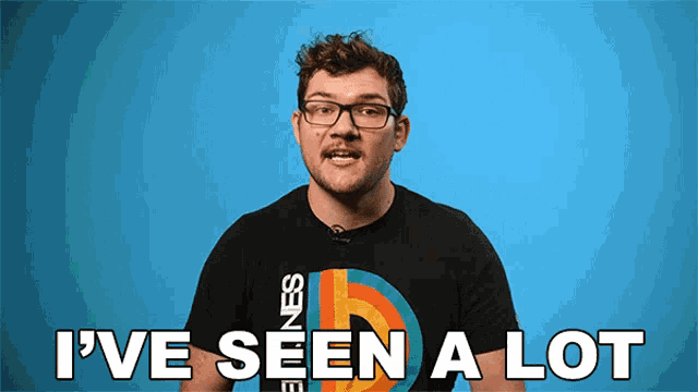 a man wearing glasses says i 've seen a lot in front of a blue background