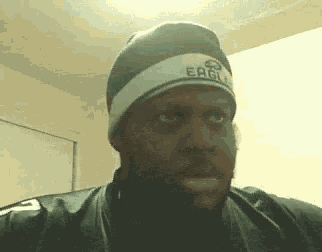a man wearing a beanie with the word eagle on it