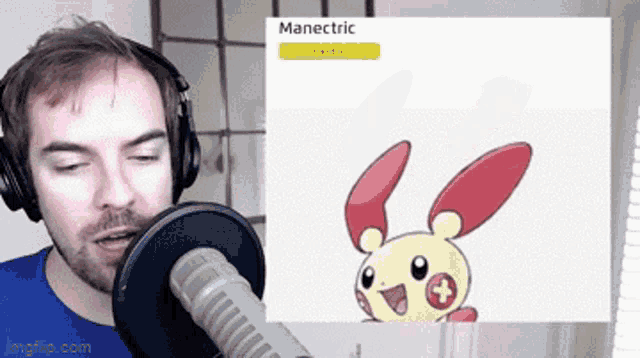 a man wearing headphones is talking into a microphone in front of a screen that says manelectric electric
