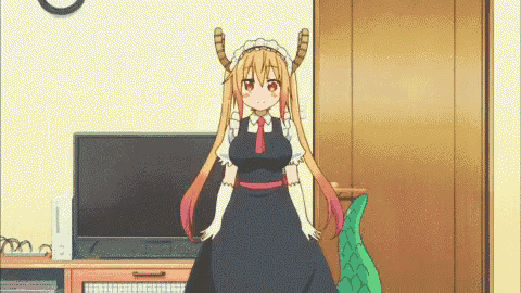 a girl in a maid outfit is standing in front of a tv