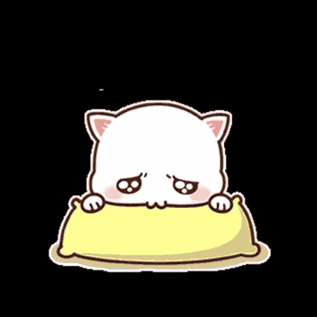 a cartoon cat is sitting on a yellow pillow with a sad face .
