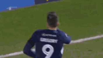 a soccer player with the name gregory on his shirt
