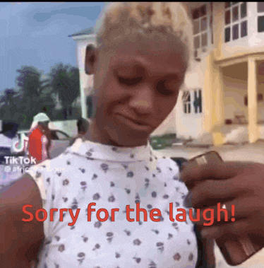 a woman says sorry for the laugh while holding a cellphone