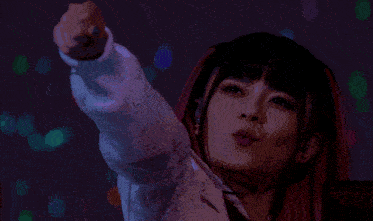 a woman is holding a blue guitar in front of a purple background