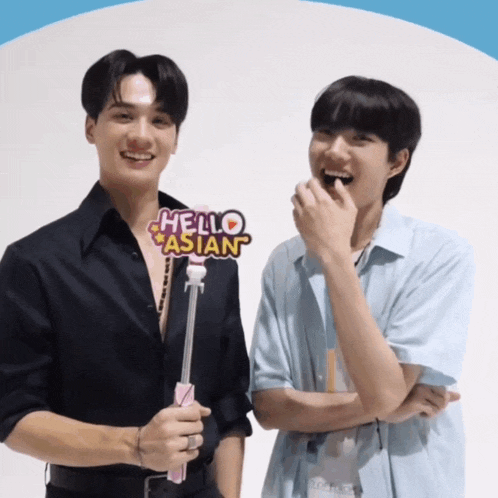 two men standing next to each other with a sign that says hello asian on it
