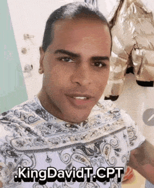 a man in a paisley shirt has the name kingdavidt.cpt on his chest
