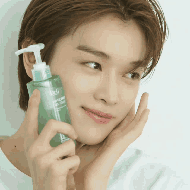 a young man holds a bottle of dr.g skin clear gel foam