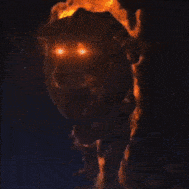 a close up of a fire coming out of the ground in the dark .