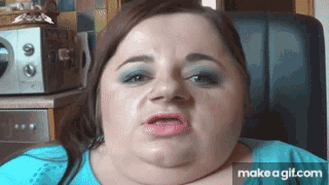 a woman is making a funny face with make a gif.com in the lower right corner