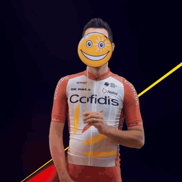 a man wearing a red and white cofidis jersey holds a lollipop