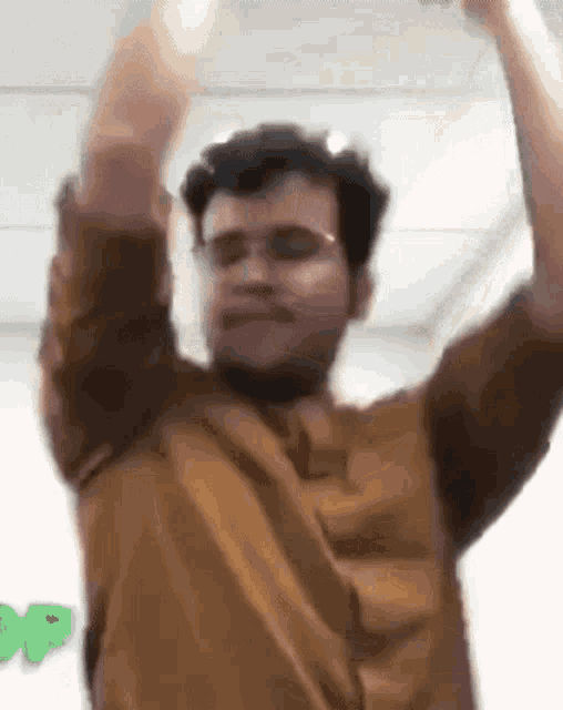 a man is dancing with his arms in the air .