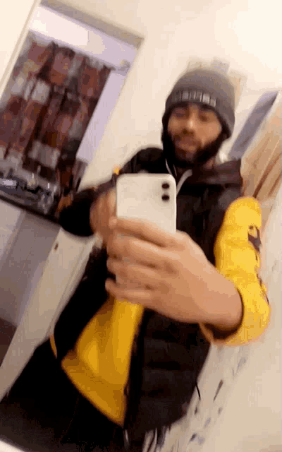 a man is taking a selfie in front of a mirror with his phone