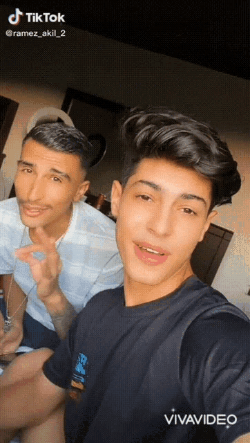two young men are posing for a selfie with the caption " tik tok @ramez_akill_2 "