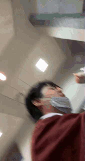 a blurry photo of a man wearing a face mask