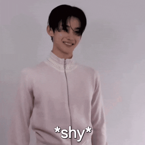 a man in a white shirt is smiling and says * shy * on the bottom